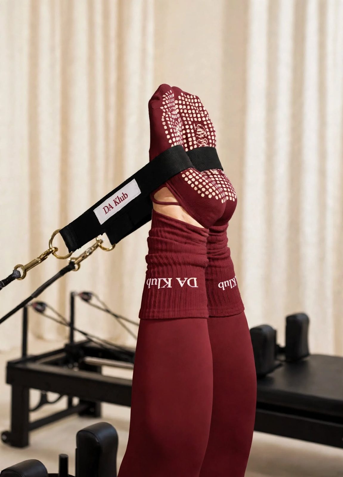 DaKlub grip socks in reformer straps